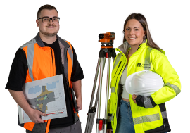 Ein Student und eine Studentin in Arbeitskleidung mit Helm und Ausrüstung
